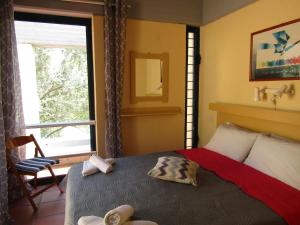 A bed or beds in a room at Barbati Beach Apartments