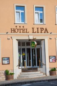 a hotel lippa building on a city street at Hotel Lipa in Bojnice