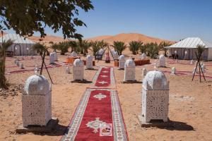 a row of gravestones in the middle of the desert at Luxury oasis camp in Merzouga