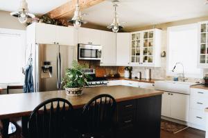 a kitchen with white cabinets and a wooden counter top at Country Barn B and B in Stirling