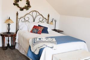 a bedroom with a white bed with blue and red pillows at Country Barn B and B in Stirling