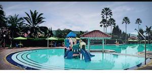 a water park with a slide in a pool at Villa kota bunga 3 BR Kolam renang pribadi in Cipanas