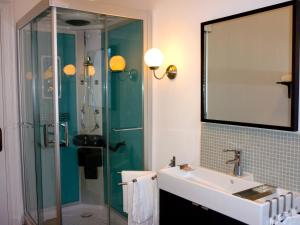 a bathroom with a glass shower and a sink at Les Gîtes Du Pays De Charleroi in Charleroi +52 photos