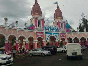 a large building with cars parked in front of it at Villa kota bunga 3 BR Kolam renang pribadi in Cipanas +2 photos
