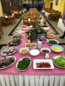 a table full of food on a pink table cloth at Kayhanbey Hotel in Kusadası