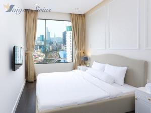 a bedroom with a white bed and a large window at Saigon Sirius in Ho Chi Minh City +36 photos