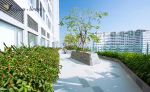 a walkway in the middle of a building with plants at Saigon Sirius in Ho Chi Minh City
