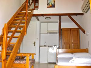 a room with two bunk beds and a staircase at Fresh Rooms in Skiathos