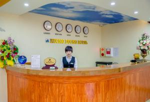 a reception counter with a picture of a woman at Huong Duong Hotel Lao Cai in Lao Cai