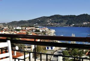 a view of a city and the water from a balcony at Fresh Rooms in Skiathos