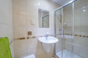 a bathroom with a sink and a shower at Electra Guesthouse in Marsalforn +24 photos