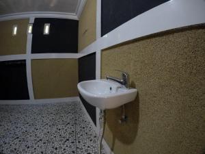 a bathroom with a sink on the wall at Khoo Villa in Senggigi 