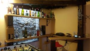 a bar with a bunch of bottles on a wall at Buio Pesto in Ceparana +33 photos