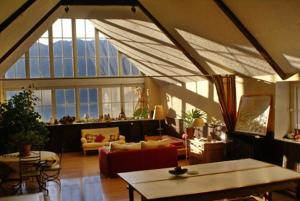 a living room with a lot of windows at Gite Auberge La Soulan - gite de montagne in Cathervielle