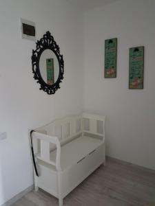 a white bed with a mirror on a wall at Viv Apartments 65 in Floreşti