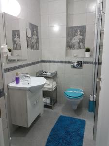 a bathroom with a sink and a toilet and a shower at Viv Apartments 65 in Floreşti +19 photos