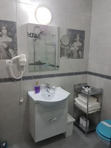 a bathroom with a sink and a mirror at Viv Apartments 65 in Floreşti