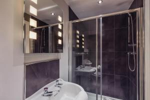 a bathroom with a shower, sink, and tub at Ambleside Townhouse in Ambleside