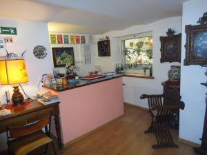 a room with a counter and a desk and a window at Hotel Morlacchi in Perugia