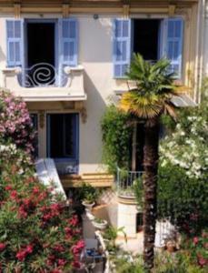 a palm tree in front of a building at Villa Saint Hubert in Nice