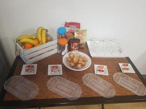 a table with a basket of bananas and a basket of fruit at Albergue Buen Camino Tui in Tui