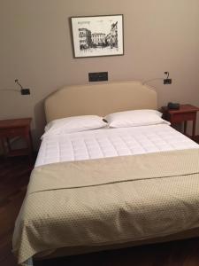 a bed in a bedroom with two nightstands and two lamps at Hotel il Cigno in Perugia