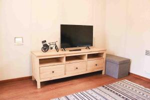 a wooden entertainment center with a flat screen tv on it at De Hoog Weyen in Halen