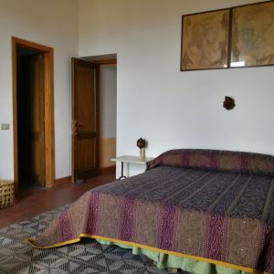 a bedroom with a bed and a table and a window at La Locanda del Barbablù in Stromboli