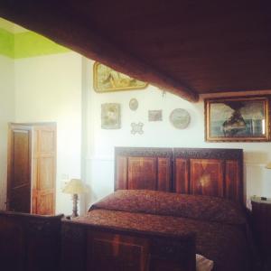 a bedroom with a bed and some pictures on the wall at La Locanda del Barbablù in Stromboli