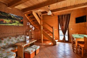 a living room with a staircase in a cabin at Domki w Istebnej in Istebna