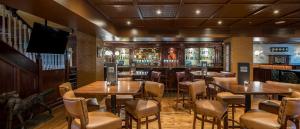 a restaurant with tables and chairs and a bar at The Johnstown Estate in Enfield