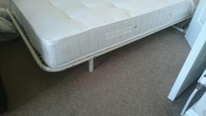 a bed in a room with a white mattress at Strathmore Apartments in Lytham St Annes