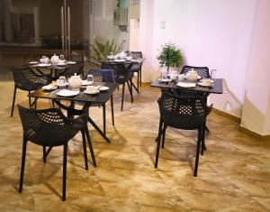a group of tables and chairs in a room at Vendol Maliga Edge in Kandy