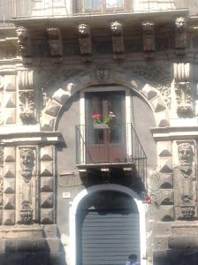 a building with a window with a flower pot on a balcony at PAPALI loft in Catania