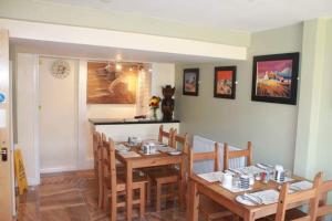 a dining room with a wooden table and chairs at Riverside Guest House in Sleaford