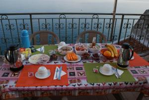 a table with food on top of a balcony at B&B Casa Armonia in Pizzo