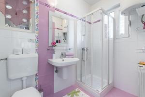 a bathroom with a sink and a shower at Allegro in Rabac +18 photos