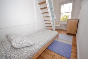 a bedroom with a bunk bed and a ladder at 20 Bellevue Road in Ryde