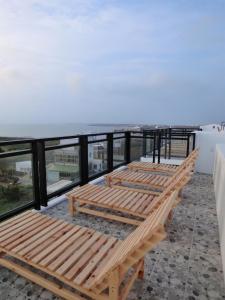 a row of wooden benches sitting on top of a roof at Happy Cape 玩皮城堡 in Huxi