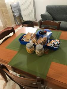 a table with a bowl of bread and containers of snacks at B&B Regina Maria in Lecce