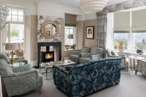 a living room filled with furniture and a fire place at Hillthwaite in Windermere