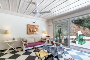 a living room with a couch and a table at Crete Retreat - Nature & Comfort Await in Ierápetra