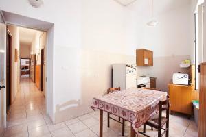 eine Küche mit einem Tisch und einem Kühlschrank in der Unterkunft Davi in Cagliari