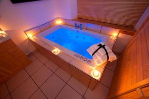 an overhead view of a tub with lights in it at Abhainn Cottage in Breasclete