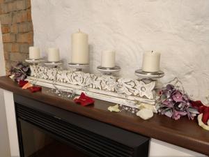 a group of candles on top of a fireplace at Podkova Omsk in Omsk