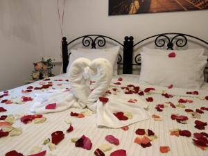 オムスクにあるPodkova Omskのベッドに横たわるバラから作られた白鳥