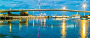 a bridge over the water at night at Altea in Pescara