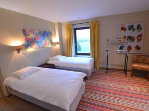 a hotel room with two beds and a window at Lovely Holiday Home in Mettet with Garden in Stave