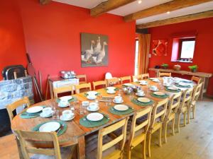 a dining room with a large wooden table and chairs at Lovely Holiday Home in Mettet with Garden in Stave
