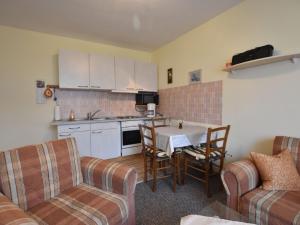 a kitchen and a living room with a table and chairs at Beautiful Apartment in Proseken with Garden in Proseken